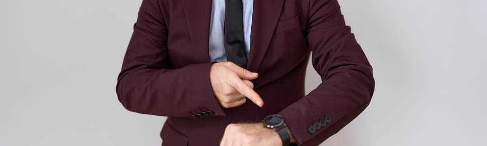 Close-up of business man indicating his watch because he's in a time crunch